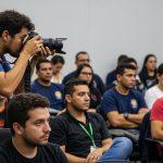 Documentary photographer capturing a Brazilian community meeting about social policy in 2026